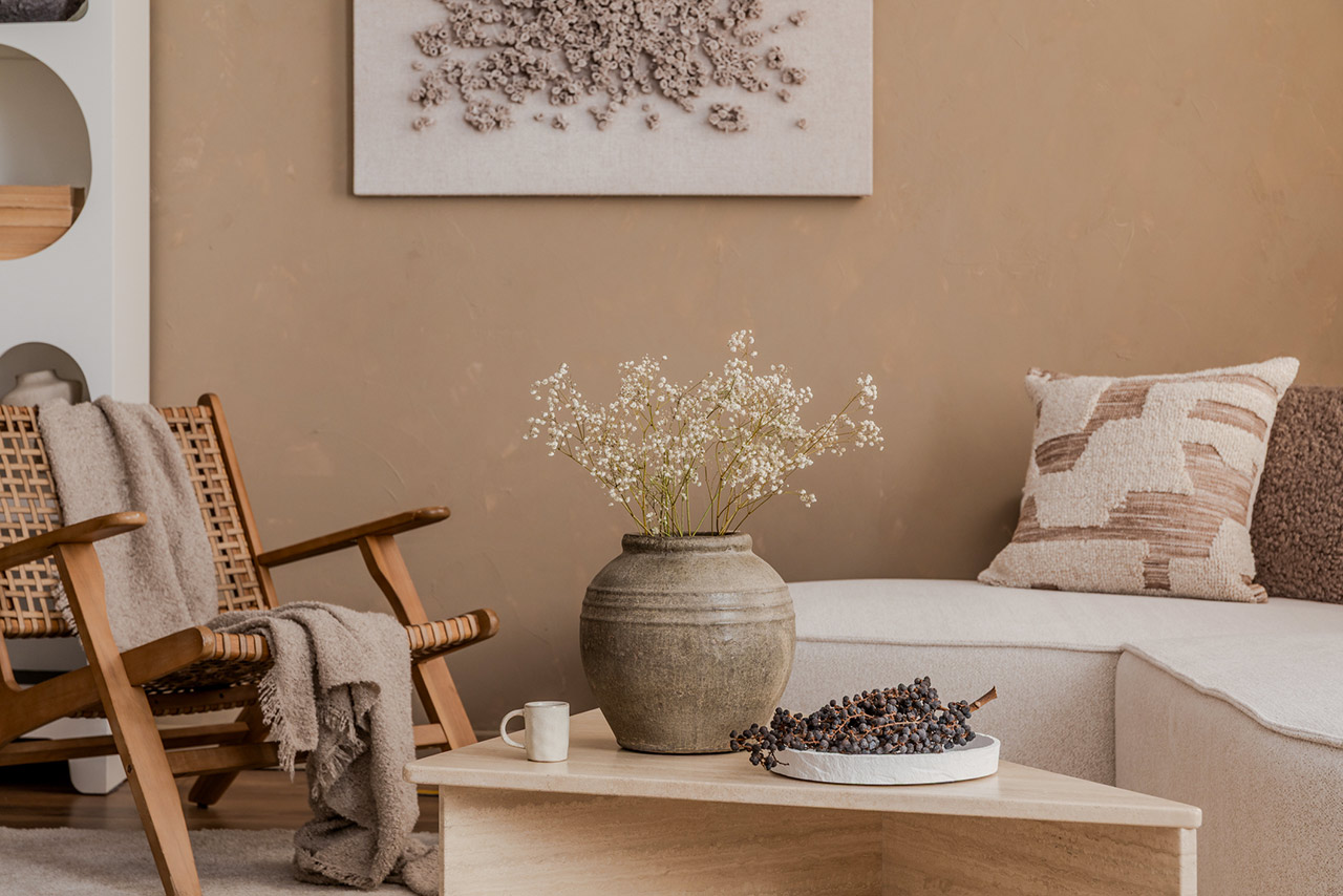 Natural-toned interior with rustic vase, textured pillows, and cozy lounge chair in a calm neutral setting stock photo